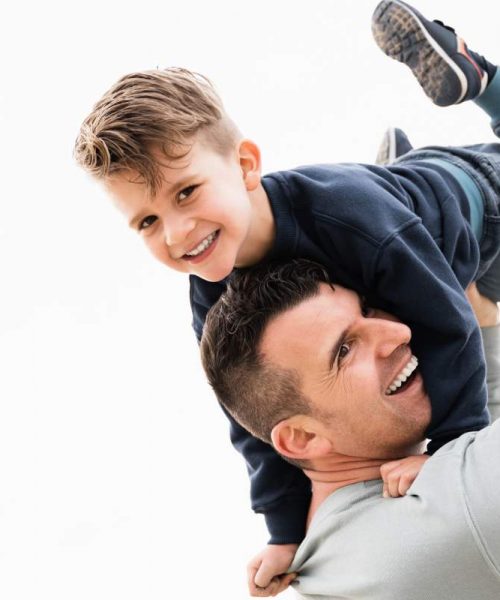 father-and-son-having-fun-at-the-beach-during-summ-HXQWD8F father-and-son-having-fun-at-the-beach-during-summ-HXQWD8F